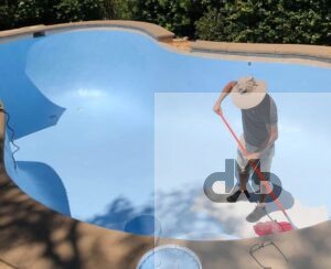 Person painting empty swimming pool